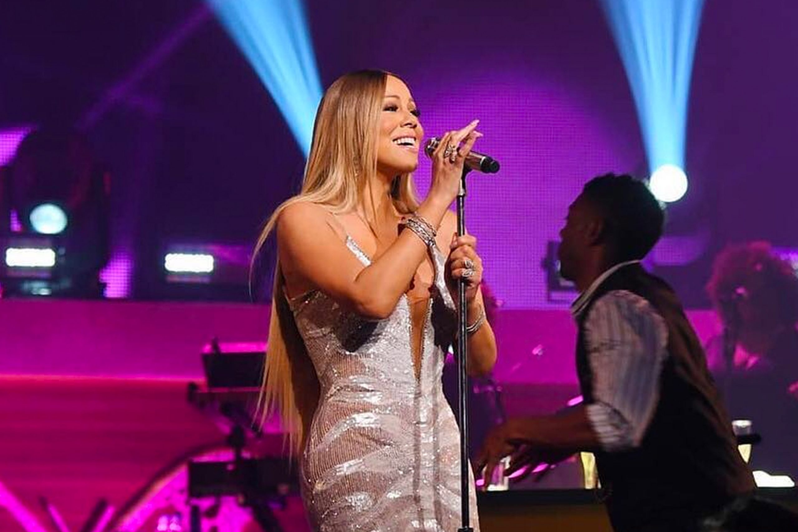 Mariah Carey singing into microphone