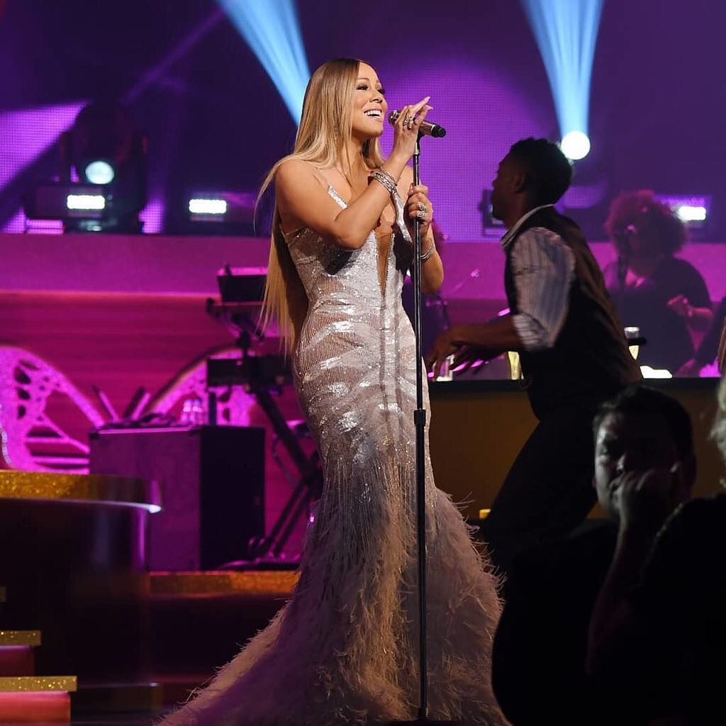 Mariah Carey singing into microphone