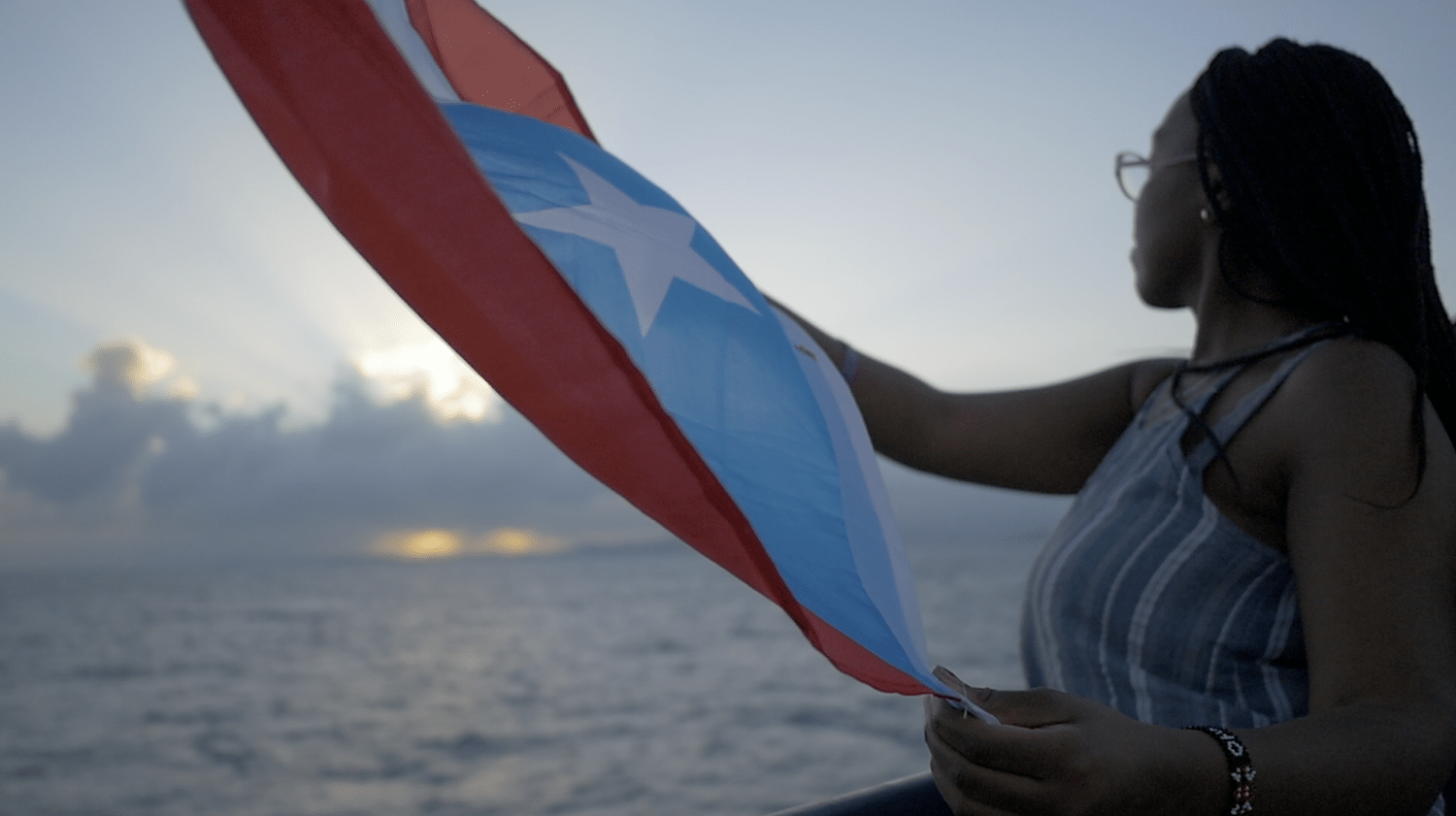 A woman holding the Puerto Rico flag