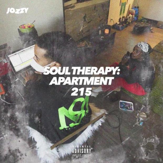 Single cover of Jozzy sitting at a laptop in an apartment